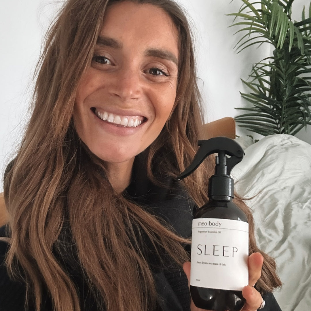 Sleep Expert Olivia Arezzolo holding meo body sleep magnesium spray