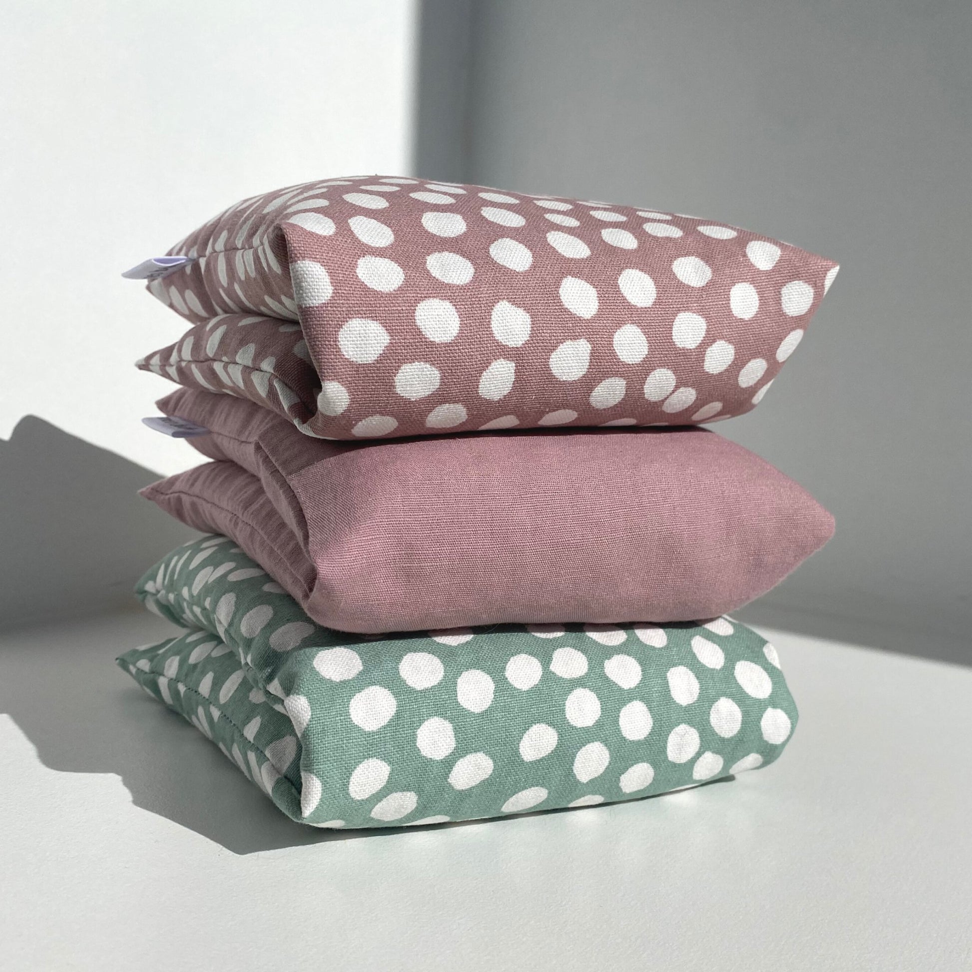 Stack of 3 heat packs (Top 'pink polka dot', middle 'pink' and bottom 'green polkadot'- Meo Body